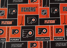 Load image into Gallery viewer, Solid Black Scrub Top with Featured Hockey Fabric on *Neck Band & Pocket Options* Medical Scrub Top Unisex Style Shirt for Men & Women