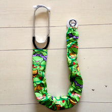 Load image into Gallery viewer, TMNT Teenage Mutant Ninja Turtles Donatello Michaelangelo Raphael Leonardo Faces Green Fabric Stethoscope sock cover for Medical Professionals